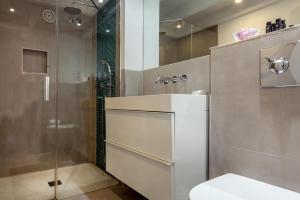 a bathroom with a shower and a sink and a toilet at La Residencia Tarifa in Tarifa