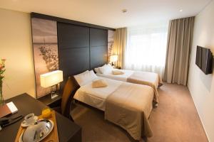 Postel nebo postele na pokoji v ubytování Amberton Hotel Klaipeda