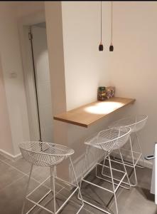 a kitchen with two stools and a counter at House By The Beach in Eilat
