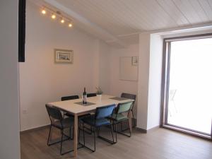 a dining room with a table and chairs at Villa Falcon in Podaca