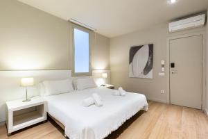 a hotel room with a bed and a television at Ola Living Hostal Diagonal in Barcelona