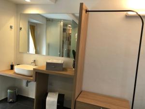 a bathroom with a sink and a mirror at Alley House in Cefalù