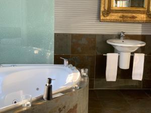 a bathroom with a bath tub and a sink at Hotel Krone Sihlbrugg in Sihlbrugg Dorf