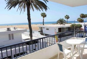 
a beach scene with a balcony overlooking the ocean at Apartamentos Oasis Maspalomas in Maspalomas
