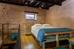 a bedroom with a bed in a brick wall at History and Charm in Chania