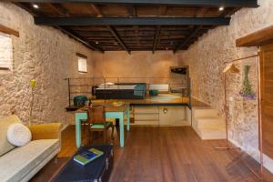 a room with a table and a kitchen with a couch at History and Charm in Chania Town
