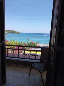a room with a view of the ocean from a balcony at Buganvilla Sea View apts in Agia Pelagia