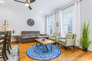 a living room with a couch and a table at Stunning 4BR-5BR near Frnch Quarter Homes by Hosteeva in New Orleans