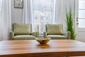 a bowl on a wooden table in a living room at Stunning 4BR-5BR near French Quarter Homes by Hosteeva in New Orleans