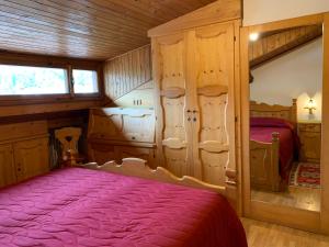 a bedroom with a bed in a wooden cabin at Attico Vista Tofane in Cortina dʼAmpezzo