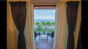 a room with a window with a table and chairs at Fantasea in Visakhapatnam