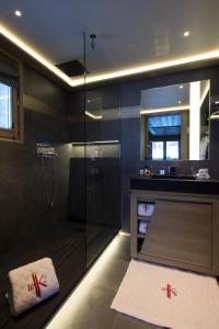 a bathroom with a shower with a glass door at Hotel Le K2 Altitude in Courchevel