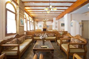 a living room with couches and a table at Acropole Delphi City Hotel in Delphi