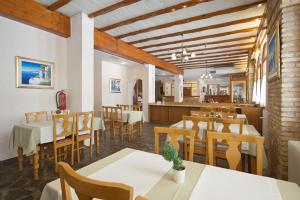 a restaurant with tables and chairs and a dining room at Acropole Delphi City Hotel in Delphi