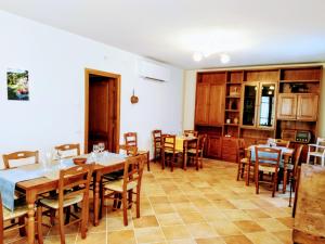 a dining room with wooden tables and chairs at Agriturismo La Vite Maritata in Pietrasanta