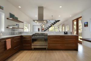 a large kitchen with wooden cabinets and a stove at Park Lane Modern in Austin