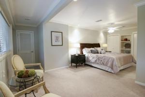 a bedroom with a bed and a chair and a table at Tarrytown Townhouse in Austin