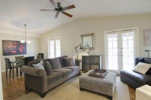 a living room with two couches and a ceiling fan at Tarrytown Townhouse in Austin