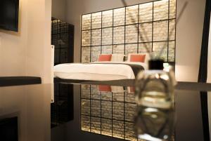 A bed or beds in a room at Magnova Studios