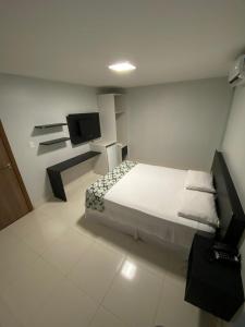 En eller flere senger på et rom på Hotel Macapaba