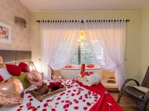 a bedroom with a bed with roses on it at Pousada Natribus Rosa in Praia do Rosa