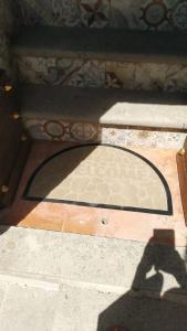 a shadow of a person standing on a tile floor at Casa Dante in Vitorchiano