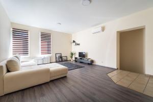 a living room with a white couch and a table at City Home Balaton in Siófok