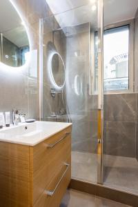 a bathroom with a shower and a sink and a mirror at CMG Champs Elysées- Boetie 4GG in Paris