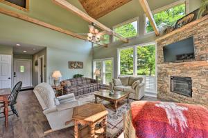 sala de estar con chimenea y pared de piedra en Renovated Home with Private Dock on Watauga Lake, en Butler