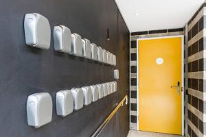 a row of cell phones on a wall at Restful Room in the City with Rooftop Terrace in Perth