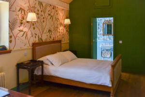 a bedroom with a bed and a green wall at The Munches Room at Buittle Castle in Castle Douglas