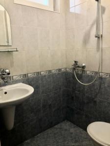 a bathroom with a sink and a shower at Семеен хотел Авалон in Chernomorets