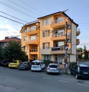 a group of cars parked in front of a building at Семеен хотел Авалон in Chernomorets