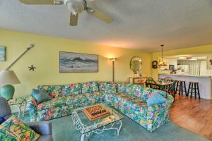 a living room with a couch and a table at Point Emerald Resort Retreat Walk to Beach! in Emerald Isle