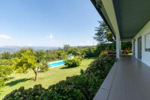 a house with a swimming pool and a yard at Capa da Encosta in Amarante