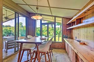 a dining room with a table and chairs at Tranquil Mid-Century Modern Cottage with Forest View in Hardy