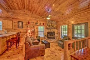 a log cabin living room with a fireplace at Ideally Located Broken Bow Cabin - Private Hot Tub in Broken Bow