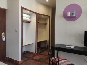 a room with a desk and a closet with a mirror at Hotel Rosario Lago Titicaca in Copacabana