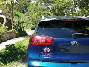 a blue car with a sticker on the back of it at Hosteria Florecer in Piñas