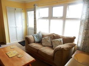 a living room with a couch and a table at Sheena's Dartmouth Chalets in Dartmouth