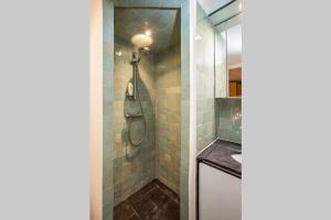 a bathroom with a shower and a sink at CHARMING LE MARAIS RETRO in Paris +30 photos