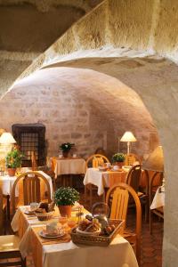 a restaurant with tables and chairs in a stone room at France Louvre in Paris
