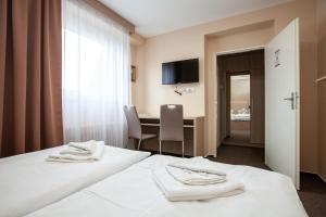 Postel nebo postele na pokoji v ubytování Hotel Stella