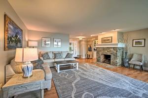 a living room with a couch and a fireplace at Lovely Waterfront Owls Head Home with Own Beach in Owls Head