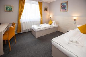 Postel nebo postele na pokoji v ubytování Hotel Stella