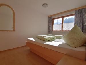 a bedroom with a bed with two pillows on it at Haus Viola in Samnaun
