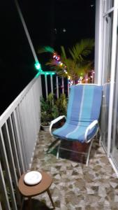 a blue chair sitting on a balcony at night at Haputale Super View in Haputale +118 photos
