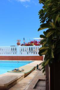 a swimming pool with a view of a building at Casa Los Palitos in Monte de Breña