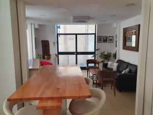 a living room with a wooden table and a couch at BE ME Hotels and Hostels HAIFA ART in Haifa