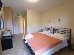 A bed or beds in a room at Queen of Orliaka